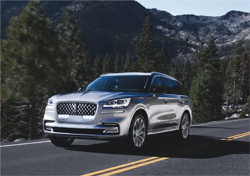 A 2023 Lincoln Aviator® Grand Touring SUV being driven on a winding road to demonstrate the capabilities of all-wheel drive | Stivers Lincoln in Waukee IA